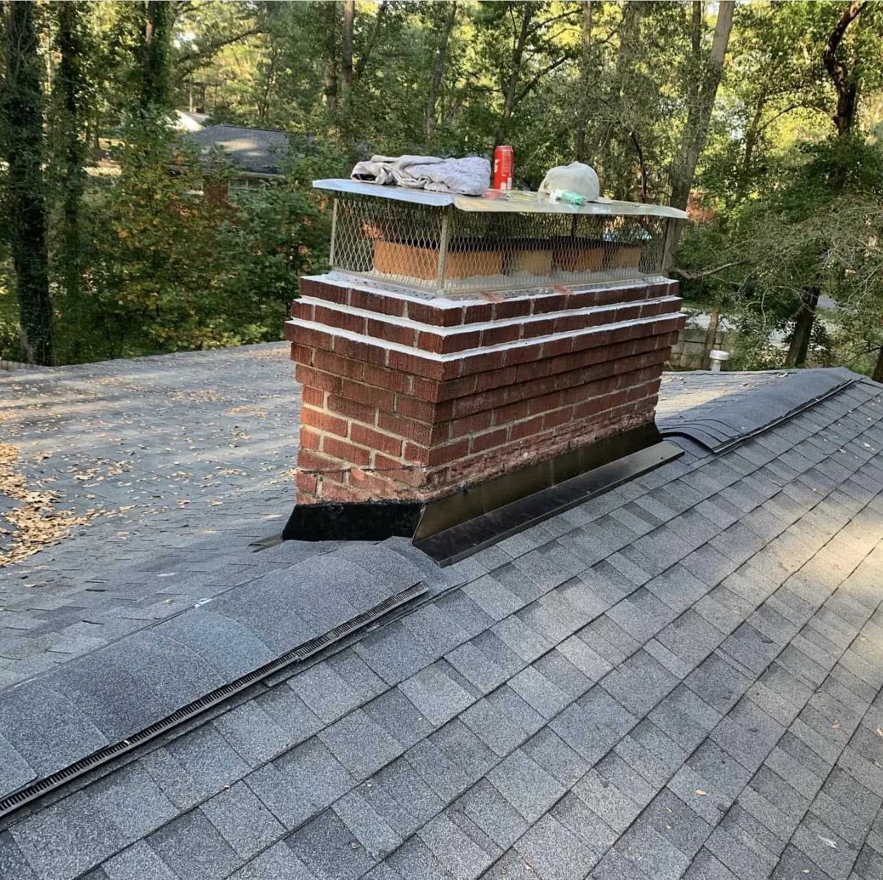 Brick chimney with new flashing and cap repair on a residential roof in New Jersey