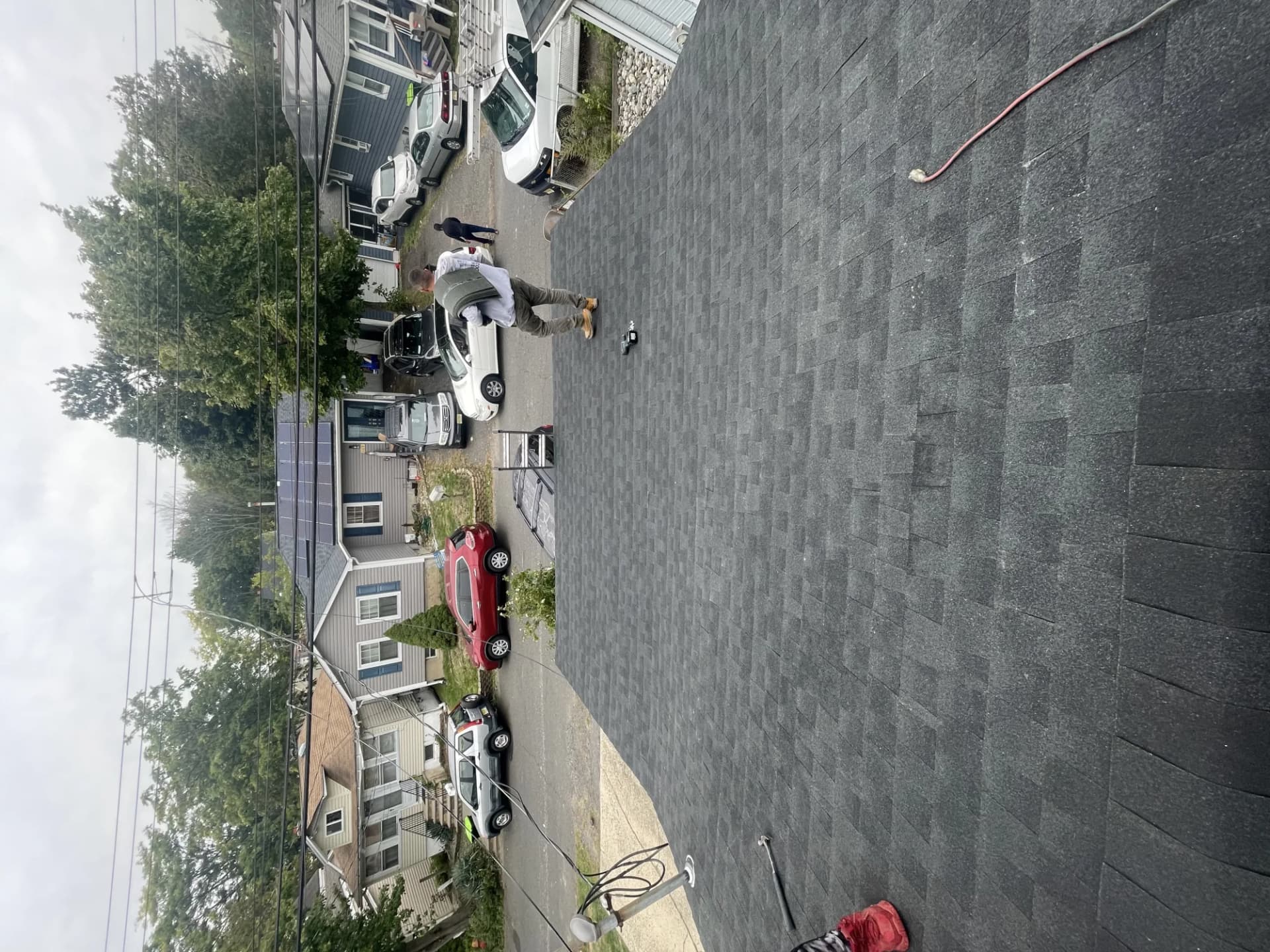 GAF FeltBuster synthetic underlayment rolled out on a roof deck with GAF shingle bundles staged for installation in New Jersey