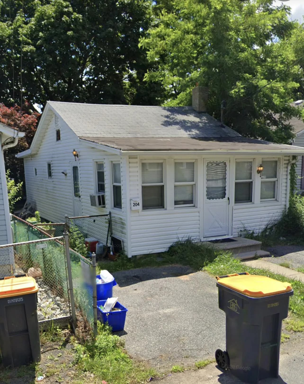 Weathered asphalt shingle roof in need of repair on a white cottage-style home in New Jersey