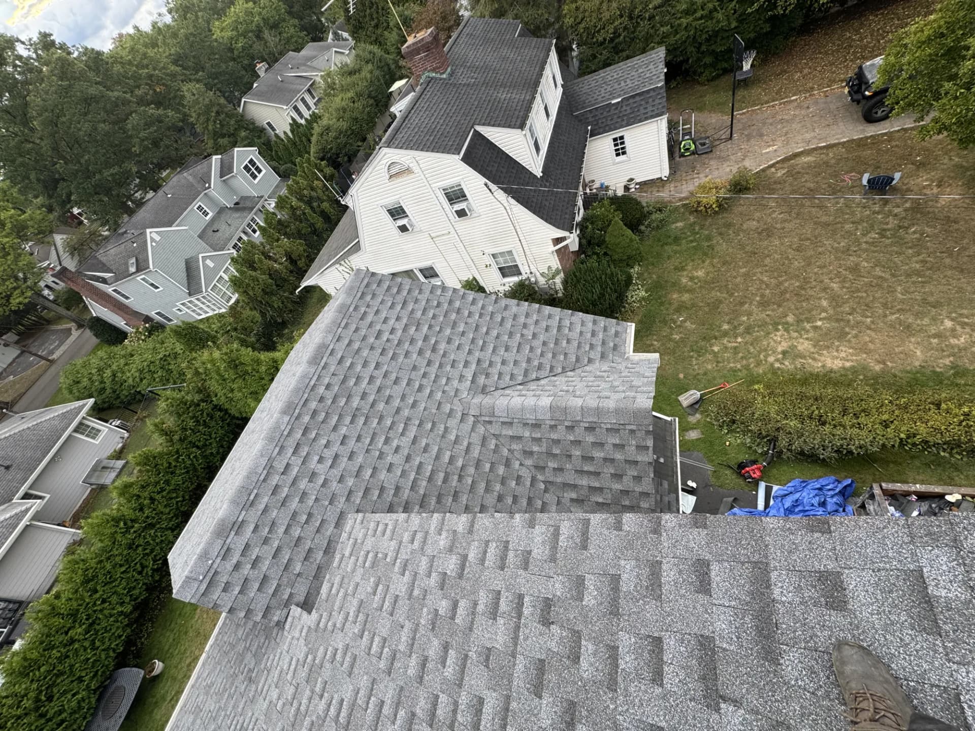 Completed gray asphalt shingle roof with multiple pitches on a New Jersey home by Alpha Pro Construction