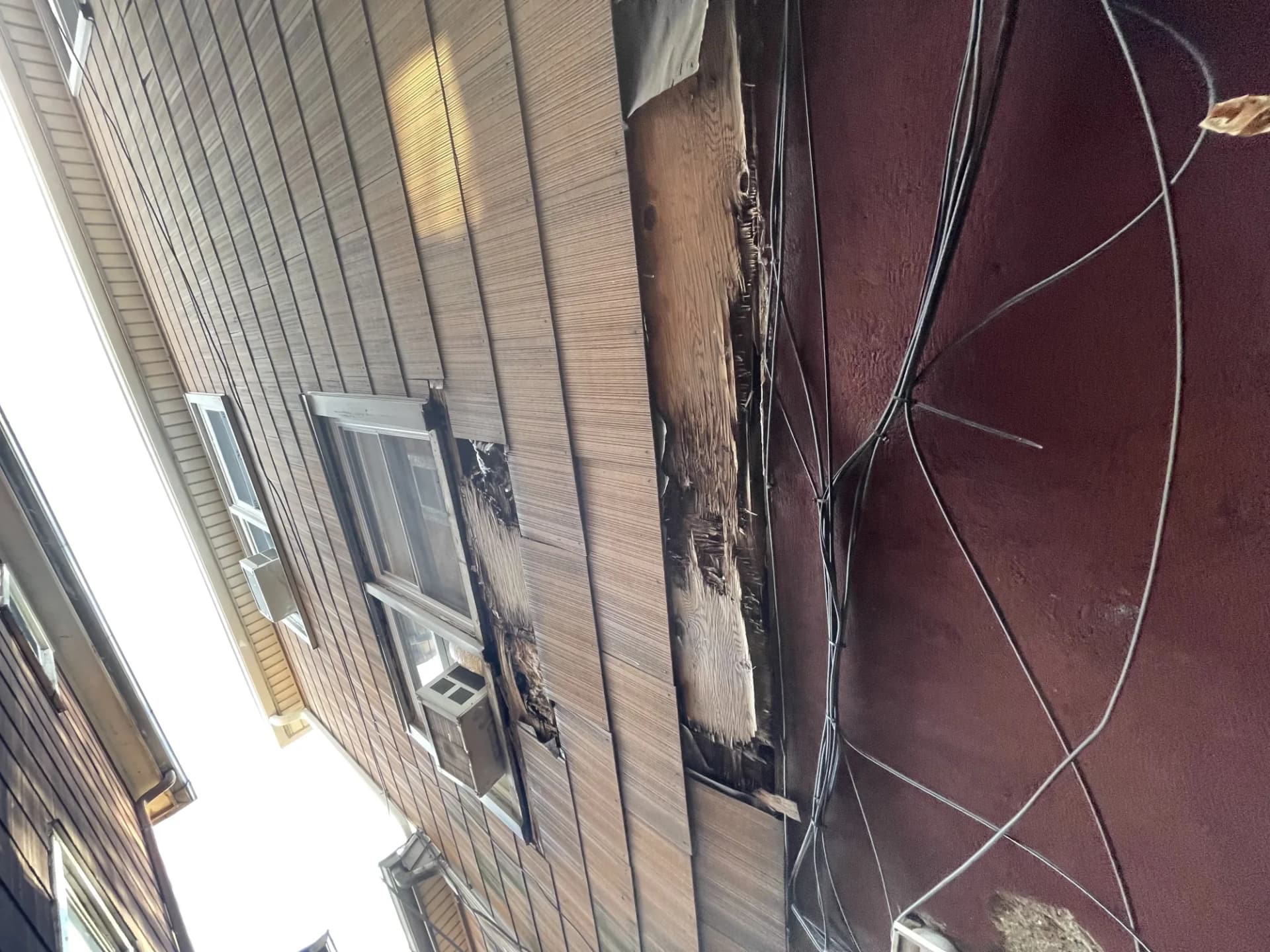 Storm and fire damaged siding and fascia on a home in New Jersey requiring insurance-covered repair