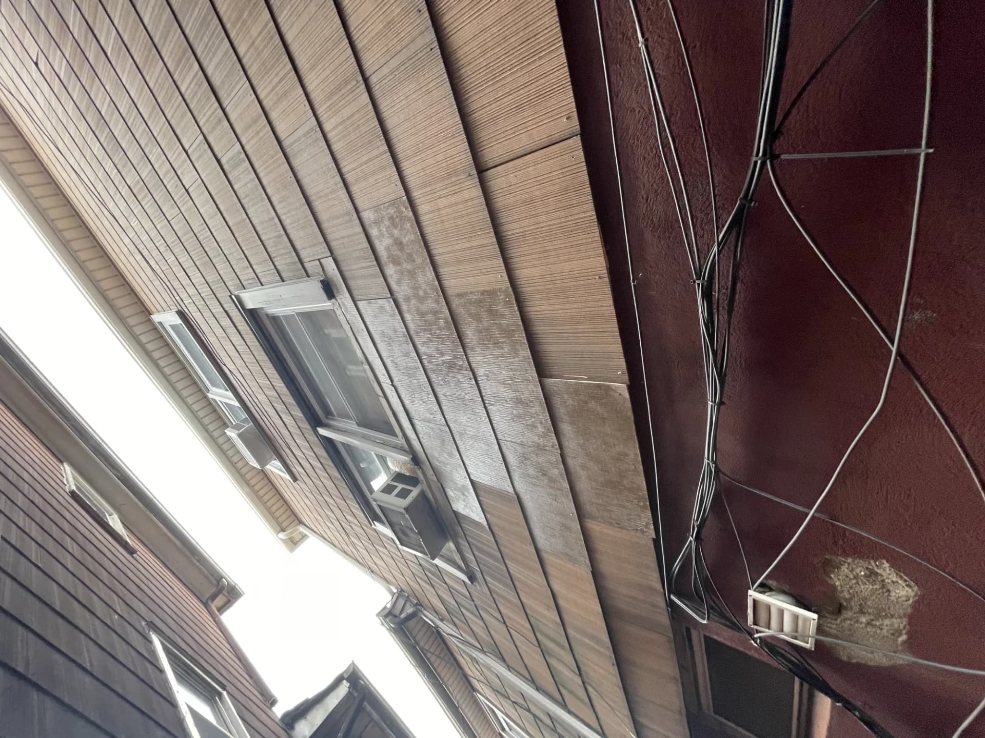 Close-up of wood soffit and fascia boards on a residential home during a roofing inspection in New Jersey